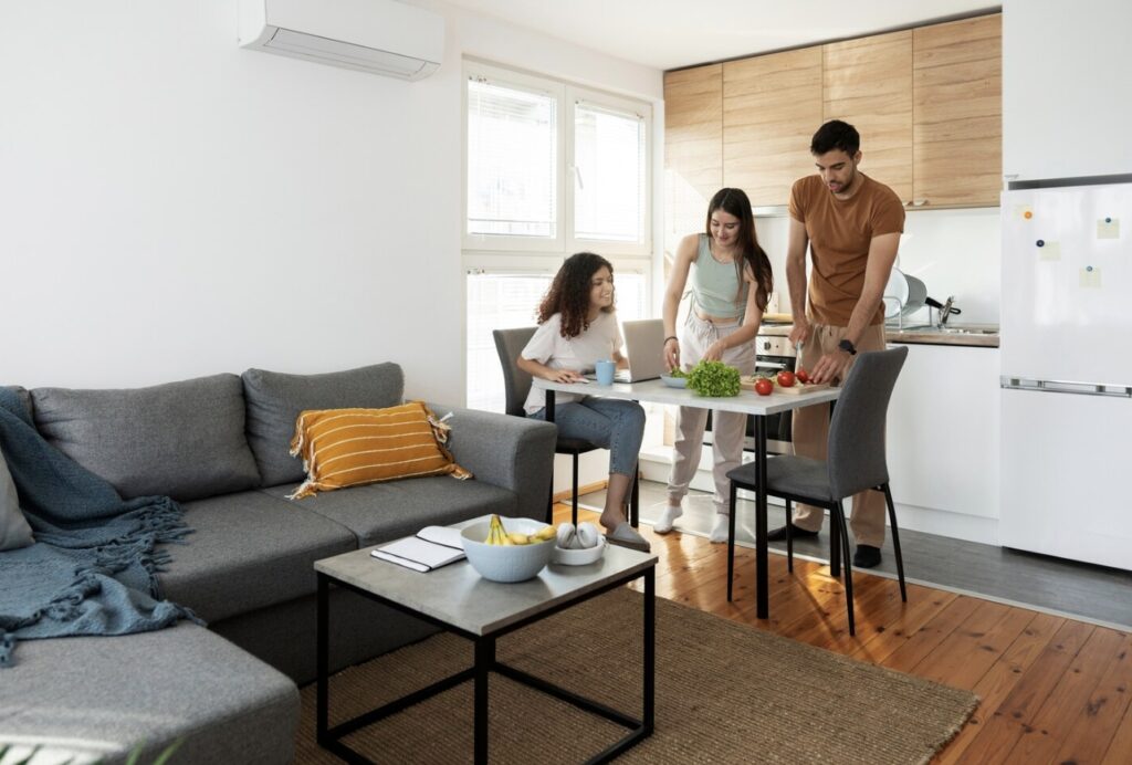 A happy family sitting together in a comfortable living room, enjoying an efficient and well-maintained air conditioner.